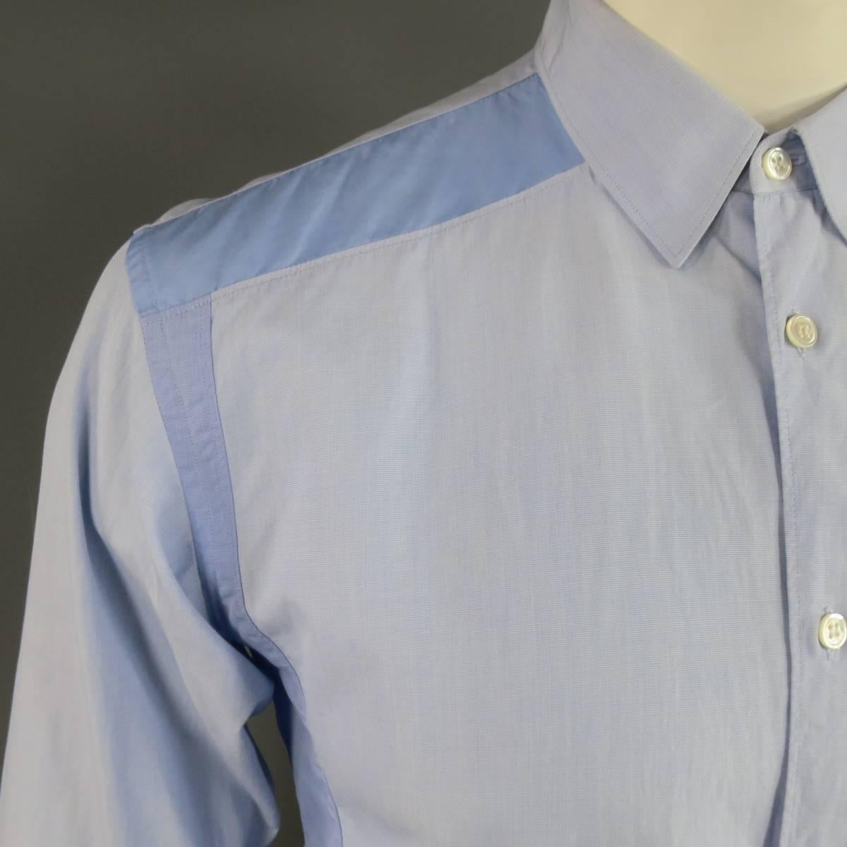 Chic COMME DES GARCONS button up shirt in a light blue textured cotton with pointed collar, patch pocket, and shoulder and side color block panels. Stain on shoulder, otherwise Excellent condition.. Made in France.
 
Good Pre-Owned