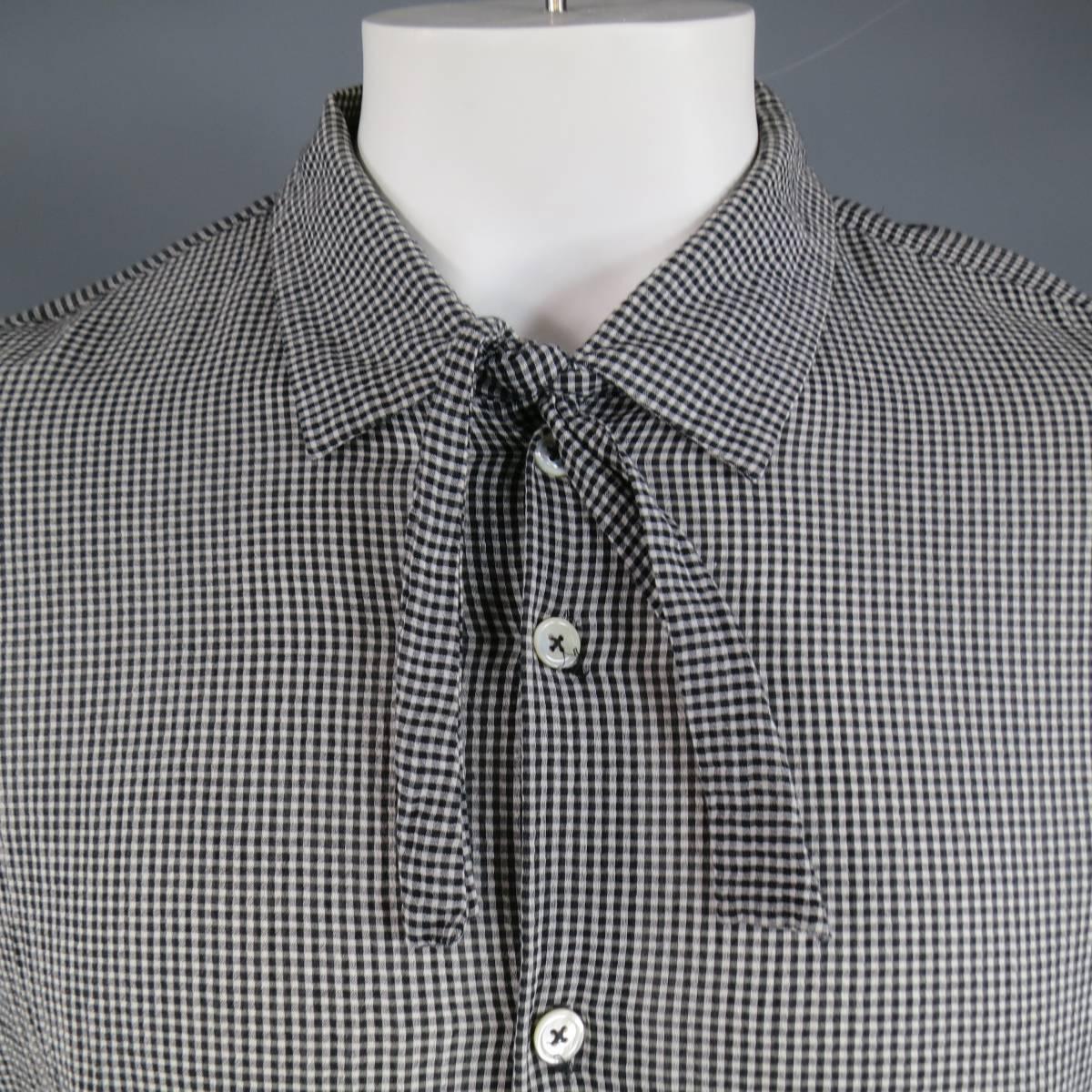 ANN DEMEULEMEESTER oversized long sleeve shirt in a textured cotton silk blend black & white micro gingham fabric with a tie closure pointed collar, button up front, and high low hemline. Stains throughout. As-Is.
 
Good Pre-Owned