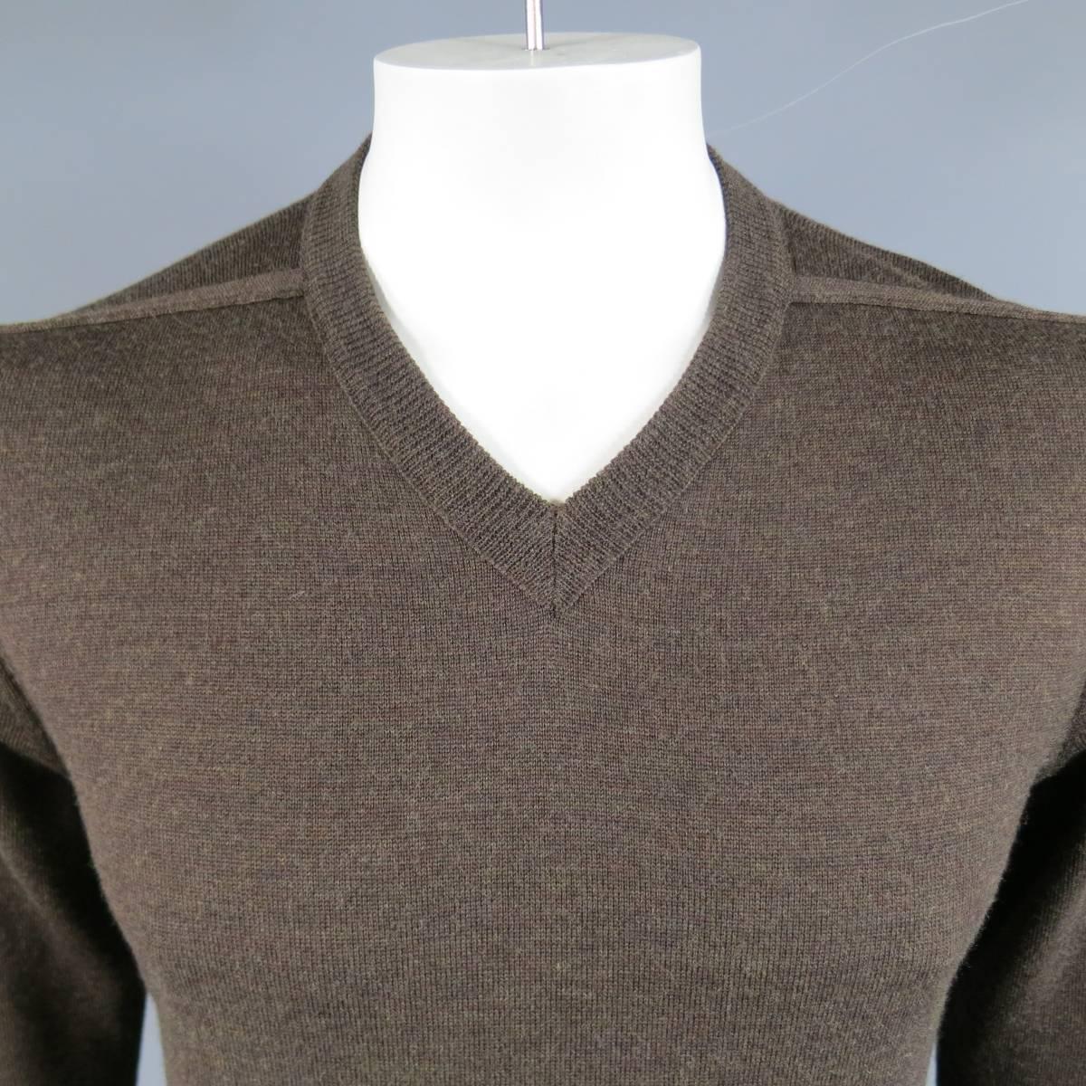 Classic Maison Martin Margiela pullover sweater in a soft, light weight Heather textured brown wool knit with a ribbed V neck line, reverse shoulder seams, and signature white back stitches.Made in Italy.
 
Excellent Pre-Owned Condition.
Marked: L
