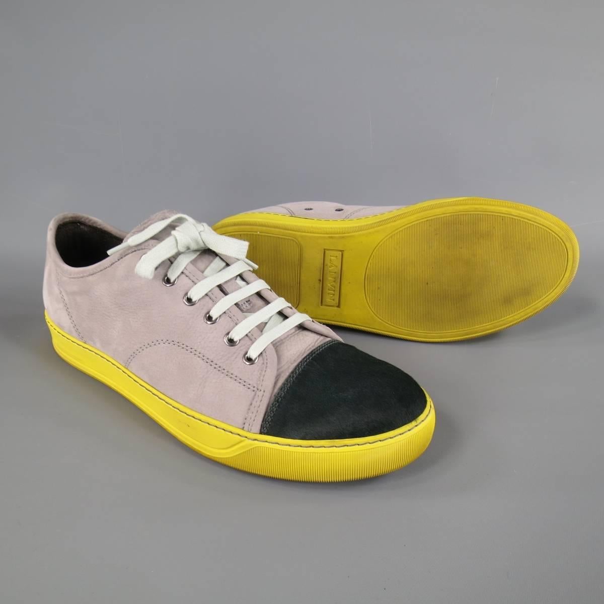 These LANVIN tennis sneakers comes in a matte taupe gray leather with a deep green pony hair leather toe cap, mint laces, and yellow rubber sole. Made in Portugal. Retails: $620.
 
Excellent Pre-Owned Condition.
Marked: UK 8
 
Insole: 11.75 x 4