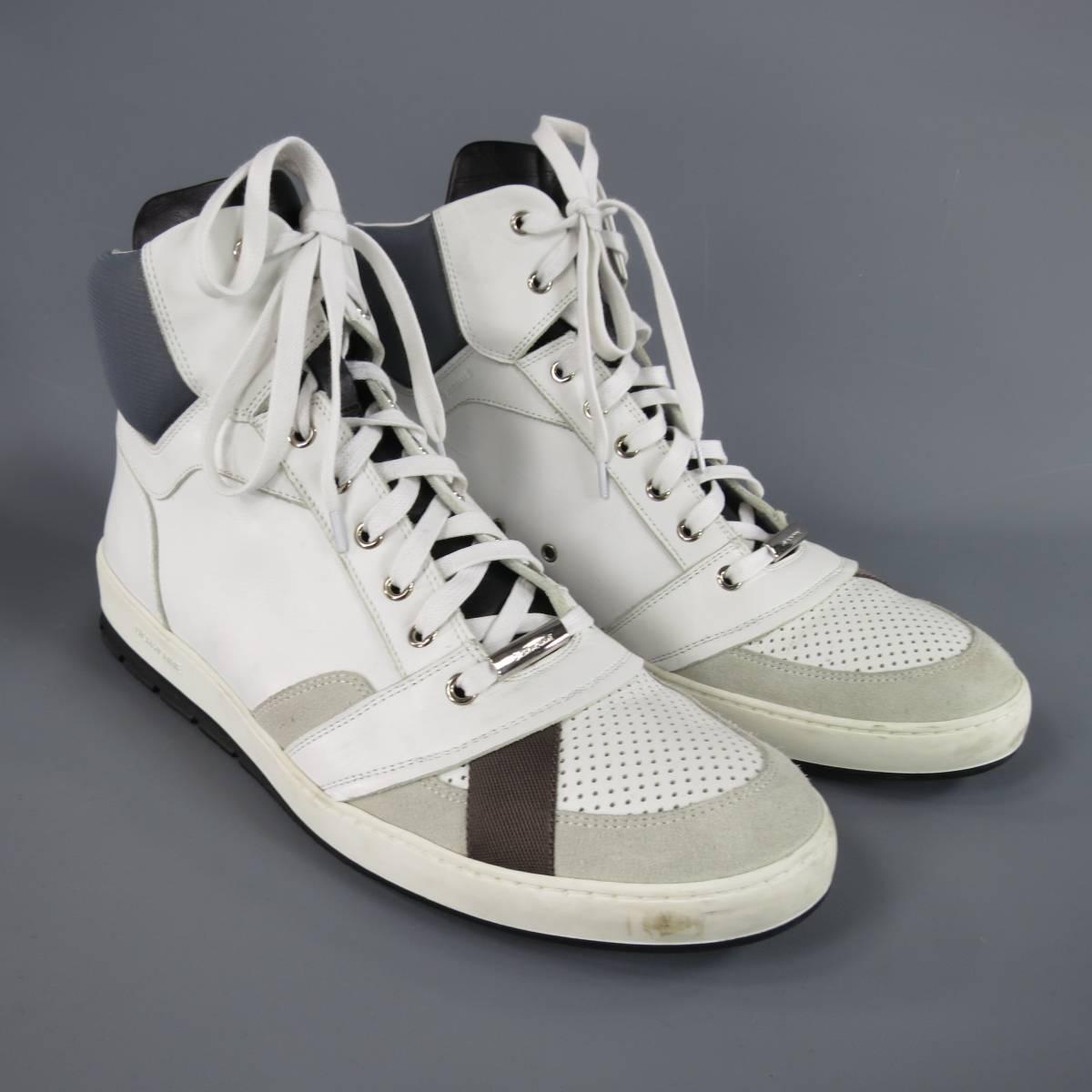 DIOR HOMME white smooth leather high top sneakers featuring a perforated toe box with brown ribbon dteail, beige suede panels, black leather tongue, silver tone engraved lace lock, gray padded ankle, and black sole with white midsole. Minor wear