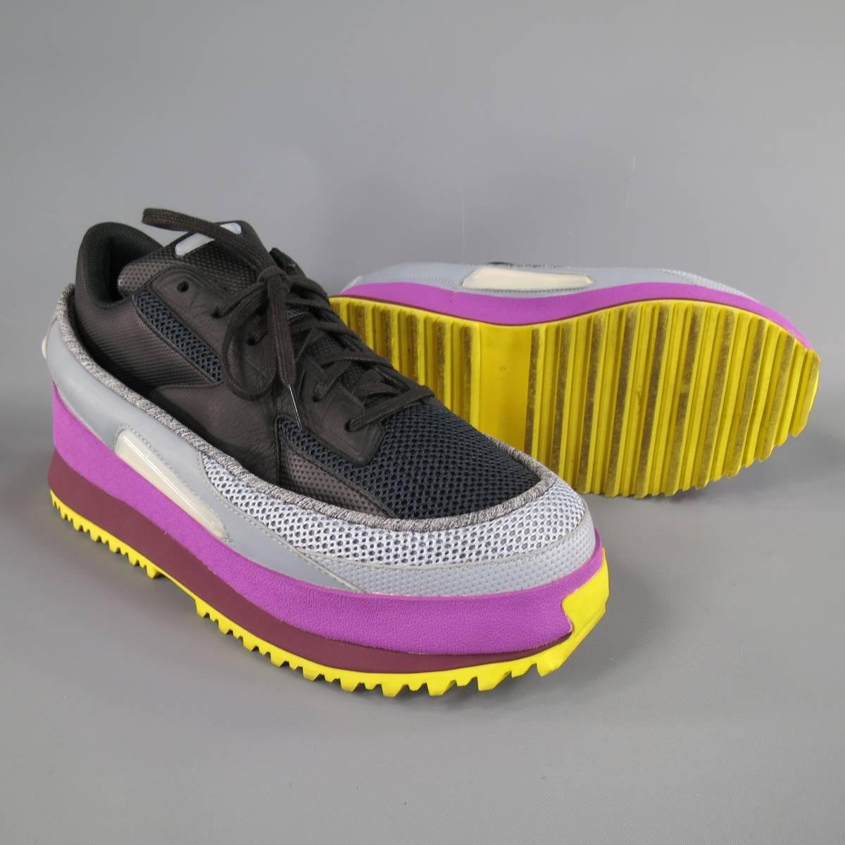 Limited Edition RAF SIMONS X ADIDAS stacked platform sneakers feature a black mesh and leather top with an outer layer of gray, orchid purple & burgundy rubber midsole, yellow sole, and light iridescent pads throughout. Runs Small.
 
Excellent
