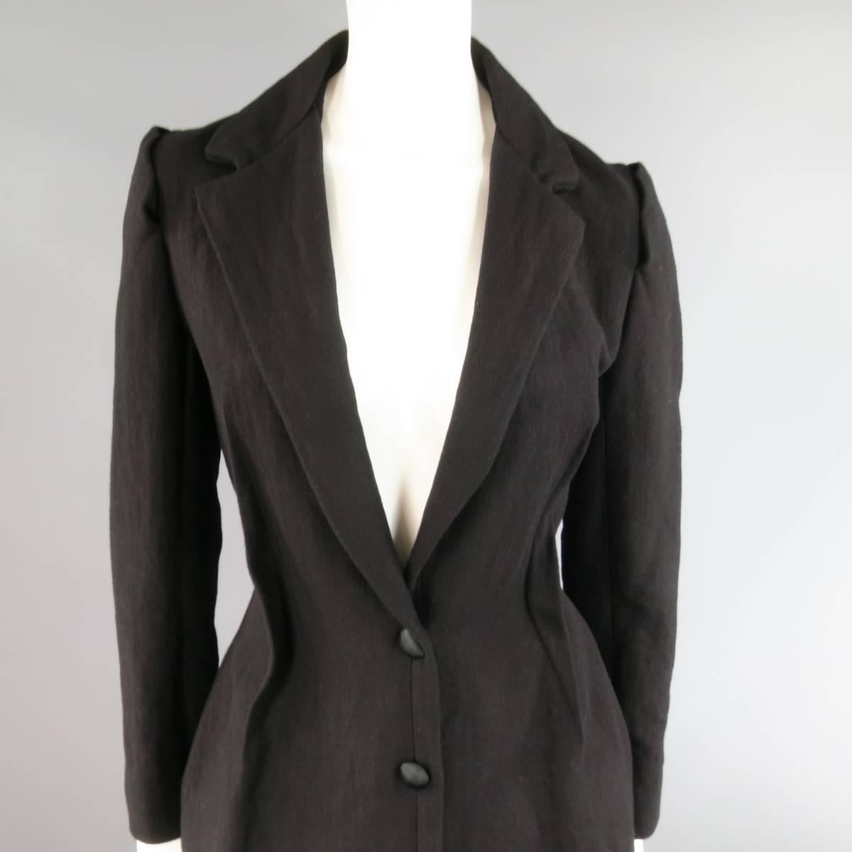 This fabulous LANVIN coat comes in a winkle textured wool, cotton, and woven metal blend and features a a notch lapel, cutout detailed shoulder seams, reverse seam darts, and tailored hourglass silhouette. Circa 2008. Made in France.
 
Excellent