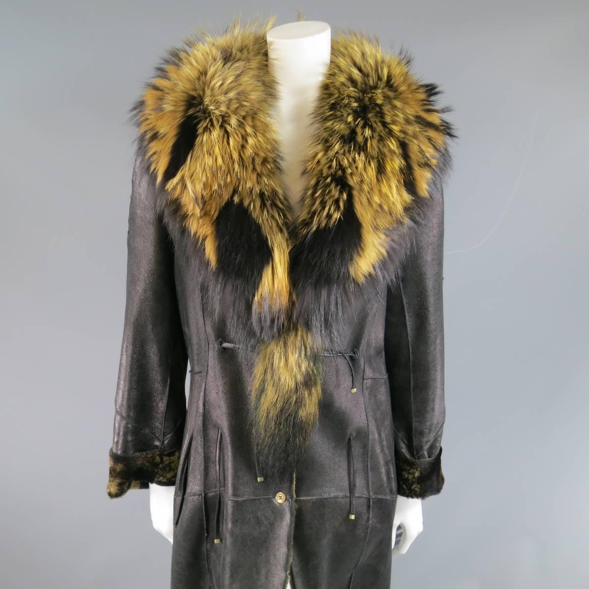 This fabulous ROBERTO CAVALLI coat comes in a shiny black patchwork leather shearing with caramel and black internal fur and features a detachable black and tan racoon fur collar with tail, button and tie closure, and cuffed sleeves. Minor wear