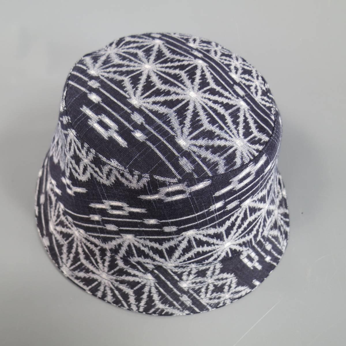 JUNYA WATANABE COMME DES GARCONS MAN bucket hat in navy and gray print with structured look and quilted brim. Made in Japan. Retails at $450.00.
 
New with Tags.
Marked: L