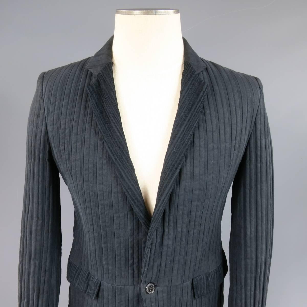 Avant garde MARKUS STITCH jacket in a stripe wrinkle textured black cotton featuring a single button closure, stripe corduroy textured notch lapel, functional button cuff sleeves, and pleated back. Fading throughout. Made in Germany.
 
Good