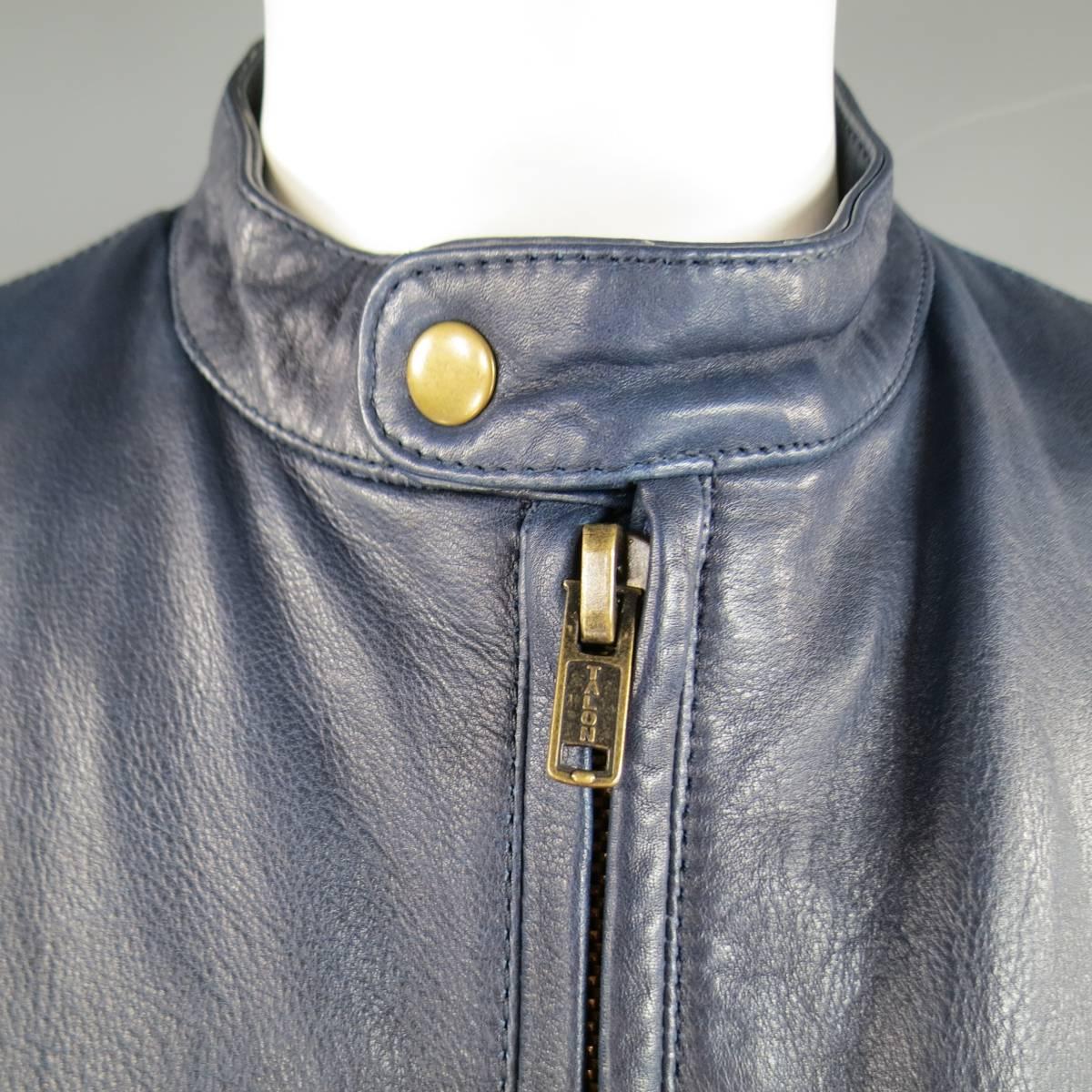 Classic fashion moto jacket by LEVI'S MADE & CRAFTED in a textured navy blue leather featuring a snap over band collar with dark gold hardware, tripe zip pockets, zip cuffs, and blue pattern lining. Made in Italy. 
Retails at $850.00.
 
Excellent