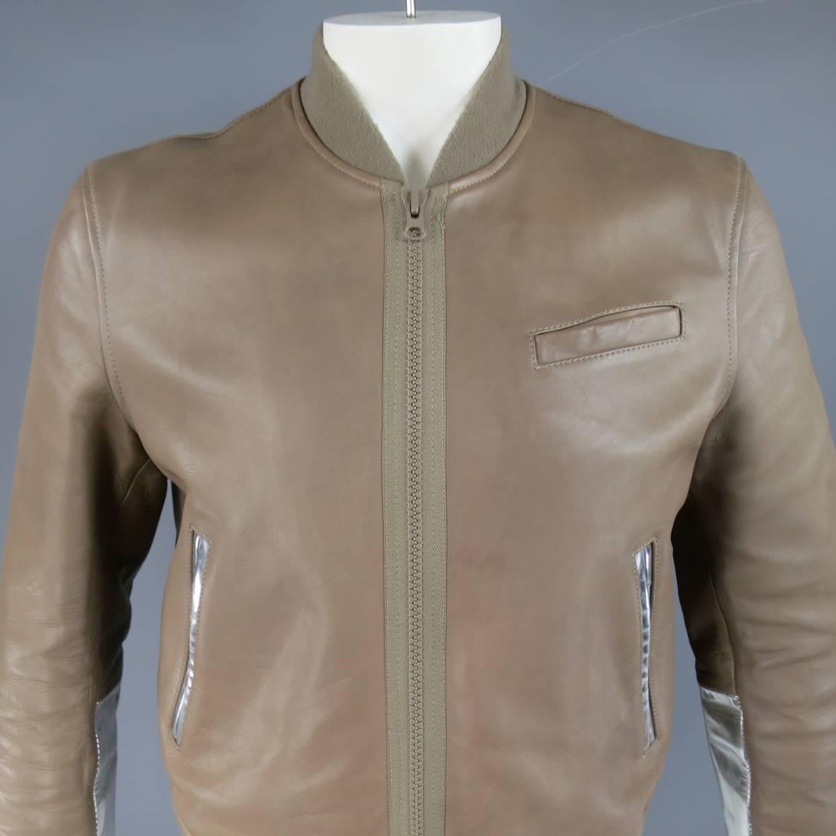 Ultra chic ACNE bomber jacket in a structured taupe leather featuring a thick beige zip closure, stretch band hems, glossy metallic silver leather panels, and elbow pads. Pilling on elastic bands and wear throughout leather. As-Is.
 
Good