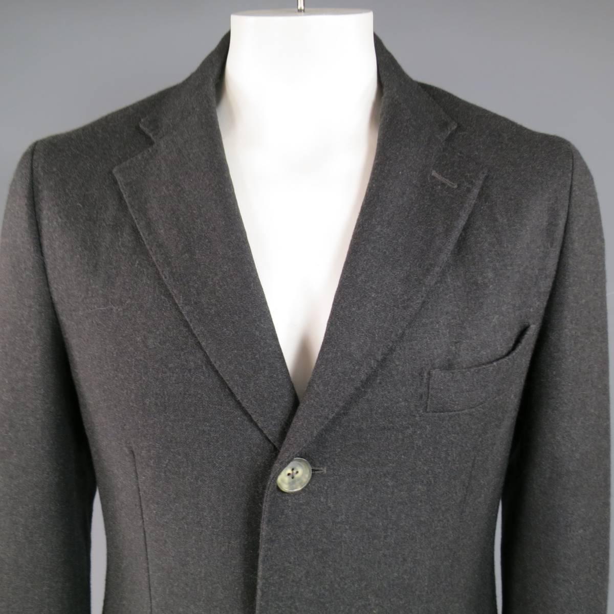 Classic ISAIA coat in a charcoal wool blend featuring a notch lapel with top stitching, light three button closure, double flap pockets, functional button cuff sleeves, and green interior. Made in Italy.
 
Excellent Pre-Owned Condition.
Marked: