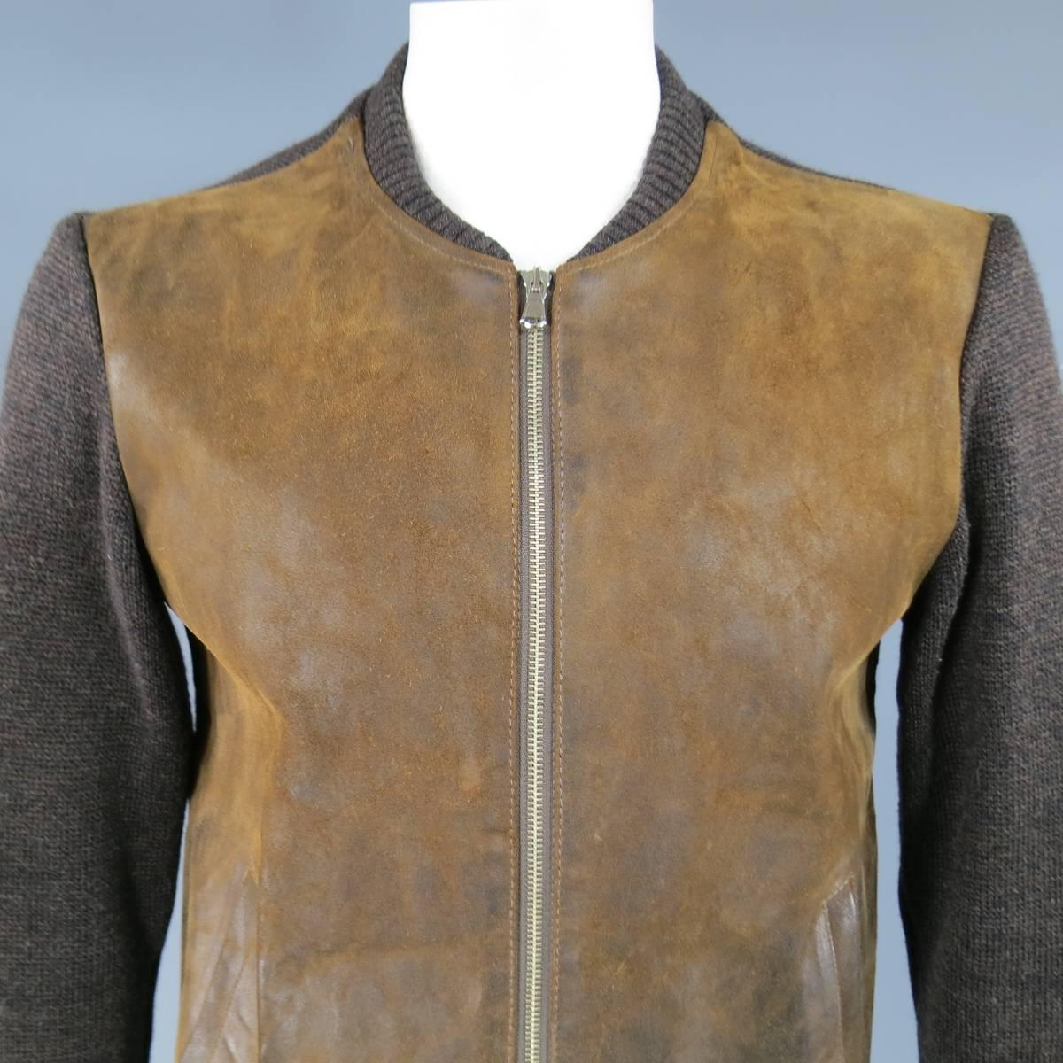 MAISON MARTIN MARGIELA bomber jacket in a thick Heather textured brown wool knit featuring a distressed tan leather zip up front, ribbed baseball collar, slanted pockets, and tan suede elbow patches.  Made in Italy.
 
Excellent Pre-Owned