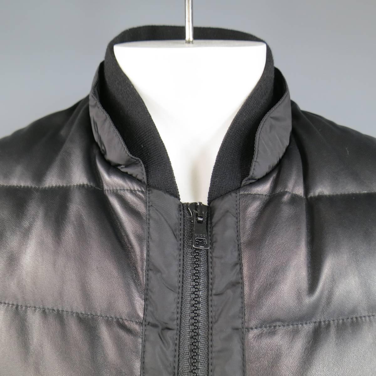 Chic GUCCI by TOM FORD puffer jacket in a black quilted, down filled, nylon featuring a soft leather front, thick double zip closure, double zip pockets, and layered baseball collar.  Made in Italy.
 
Excellent Pre-Owned Condition.
Marked: IT