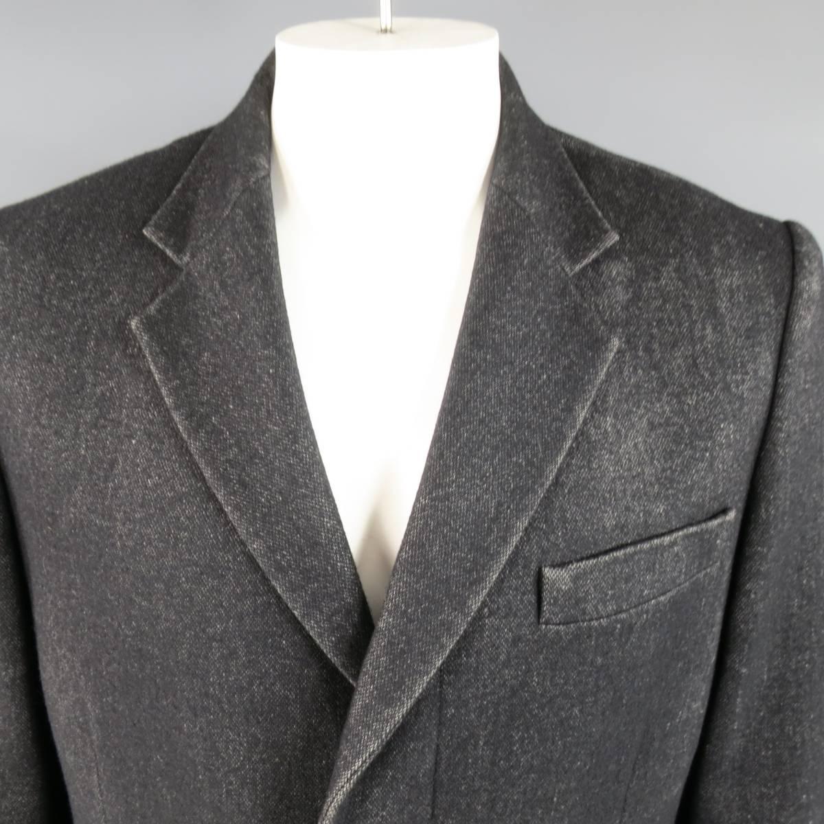 Classic MAISON MARTIN MARGIELA notch lapel coat in a unique black Heather textured wool blend with distressed look qualities throughout featuring a hidden placket button up closure, double flap pockets and single vented back. Made in Italy.
