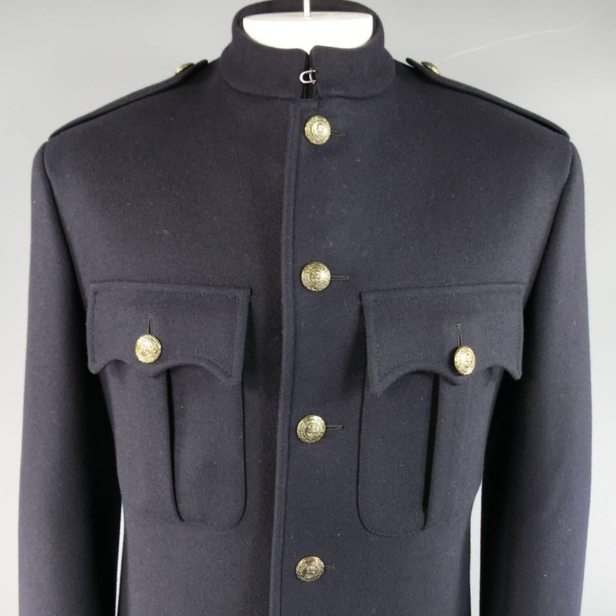 Classic RALPH LAUREN PURPLE LABEL military jacket in a deep Midnight navy blue wool cashmere blend and features a band collar with hook eye closure, double patch flap breast pockets, epaulets, and muted gold tone anchor engraved buttons. Missing