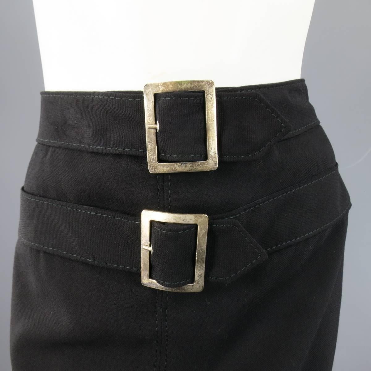 This fabulous VALENTINO pencil skirt comes in a light weight virgin wool and features a frontal zip closure, double belts with oversized antique silver buckles and satin lining. Made in Italy.
 
Good Pre-Owned Condition.
Marked: US 2
