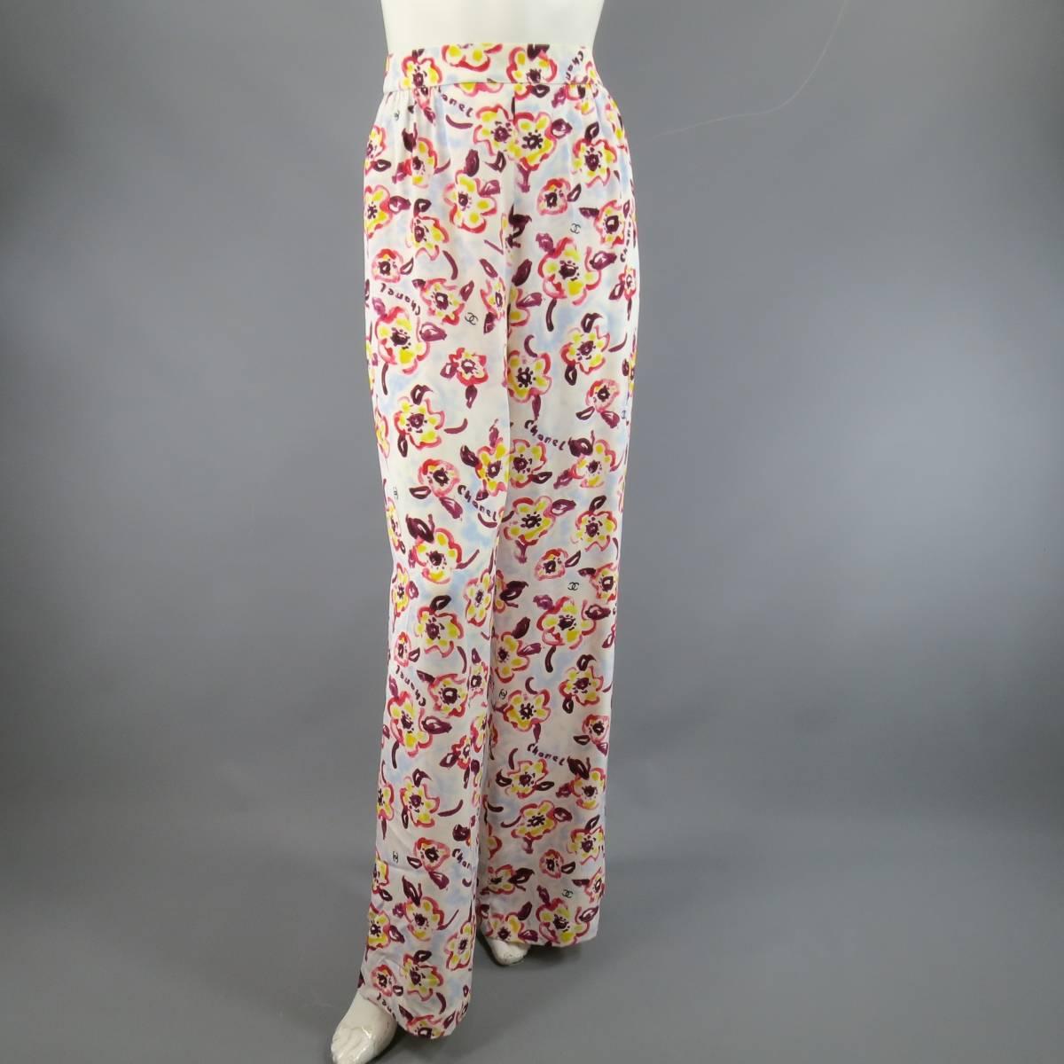 These fun CHANEL 1996 Cruise Collection trousers come in a light weight, flowy cream silk with all over sky blue, pink, yellow, and purple watercolor floral CC print and feature a high rise, gathered pleats, and wide legs. Some marks on back shown