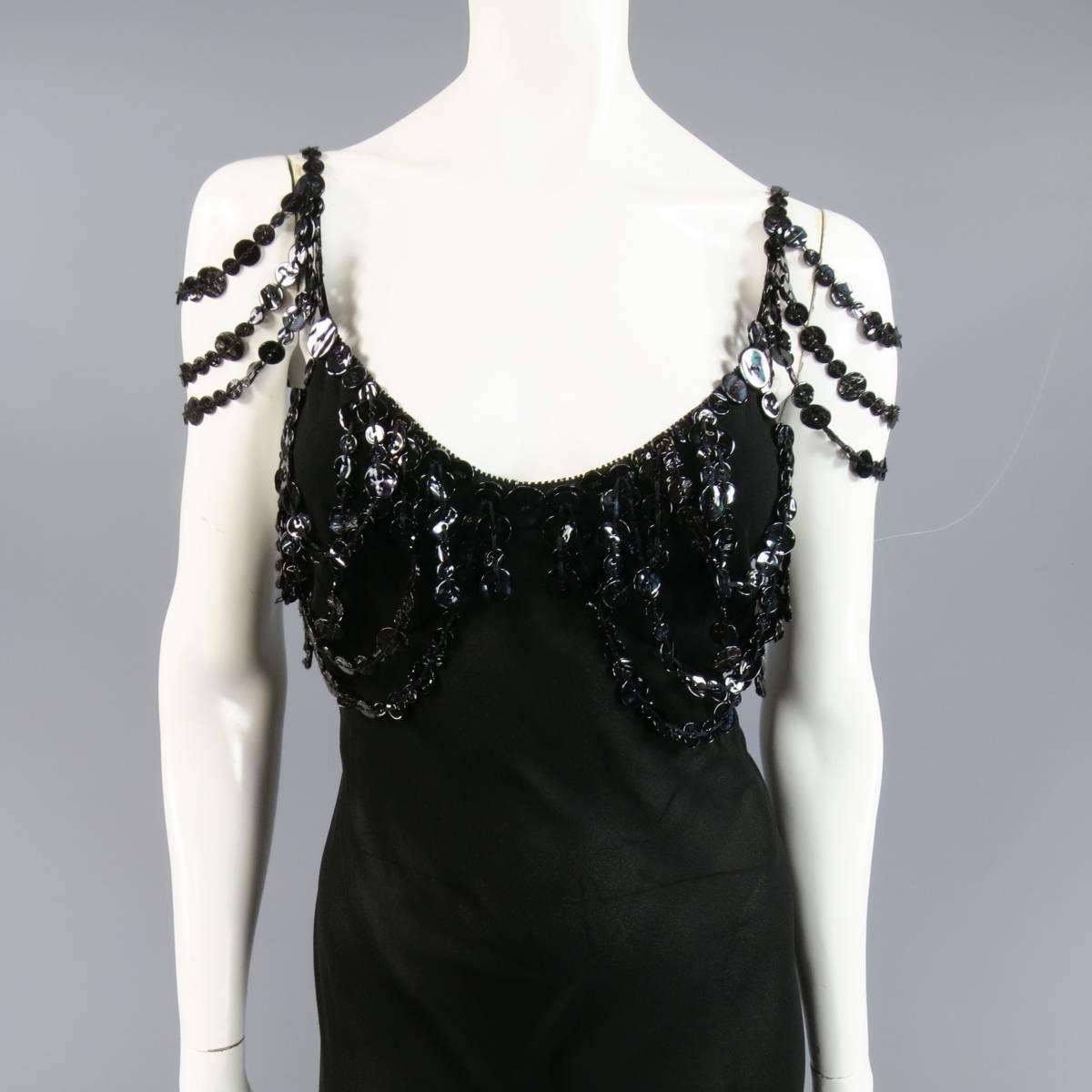 This stunning JEAN PAUL GAULTIER cocktail dress comes in a sheer black crepe and features a slip cut sheath style, tiered shoulder straps with oil slick black buttons, and layered button embellishments along the bust line. Made in Italy.
 
Good