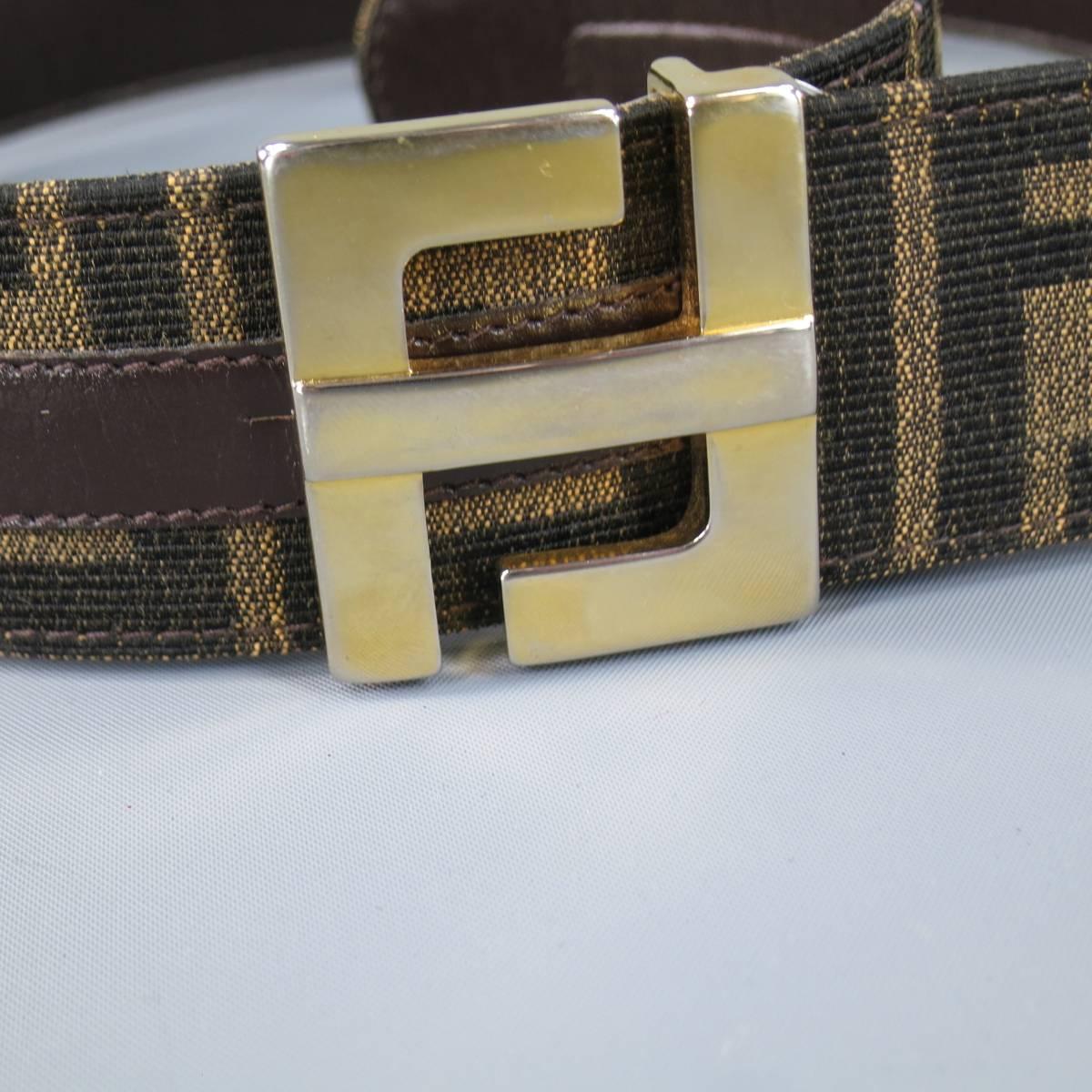 Vintage FENDI belt in signature leather lined monogram FF canvas with gold tone buckle. Minor wear and fading on buckle. Made in Italy.
 
Good Pre-Owned Condition.
Marked: 70/28
 
Length: 32 in.
Width: 1.75 in.
Fits: 24.5-28.5 in.
