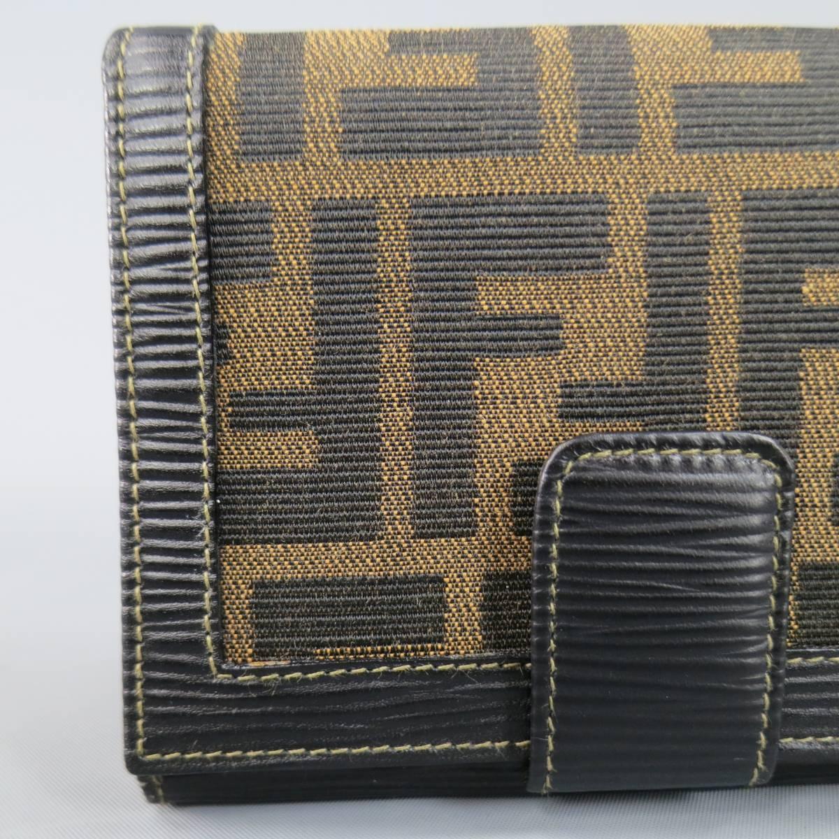 Vintage FENDI wallet in signature tan and brown FF monogram canvas with black epi textured leather details featuring a snap closure, leather interior with contrast stitching, and snap pouch. Made in Italy.
 
New without Tags.
 
Length: 5
