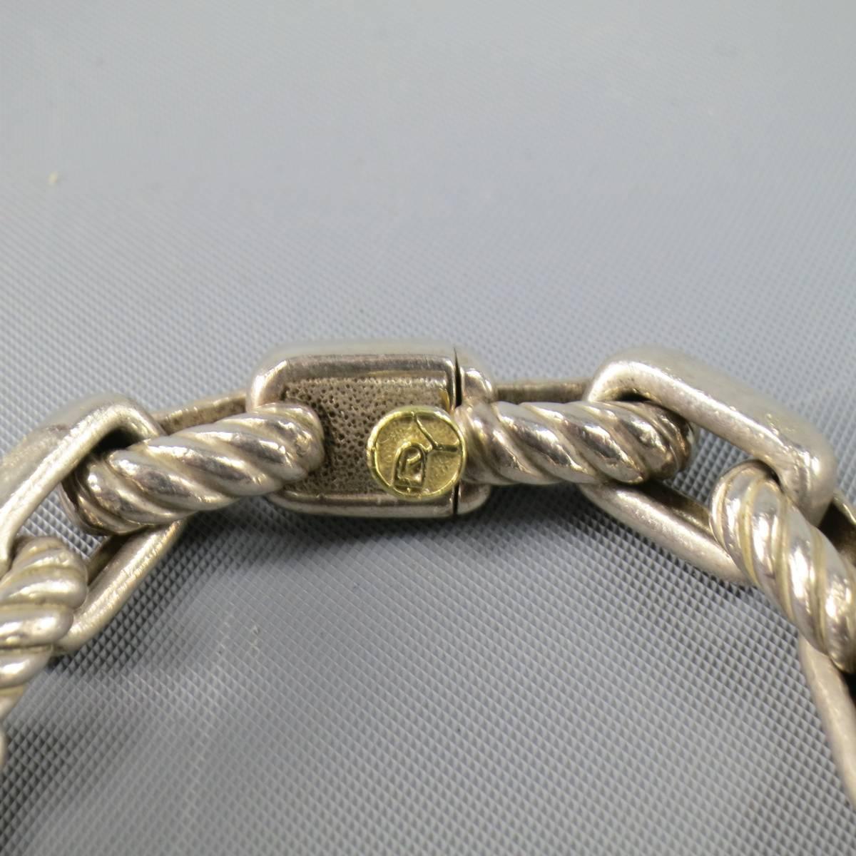 DAVID YURMAN matter sterling silver bracelet in a large rectangular chain with textured and smooth links with 14k gold closure detail.
Retails at $450.00.

Good Pre-Owned Condition.
Marked: 925 / 750
 
Length: 8.5 in.