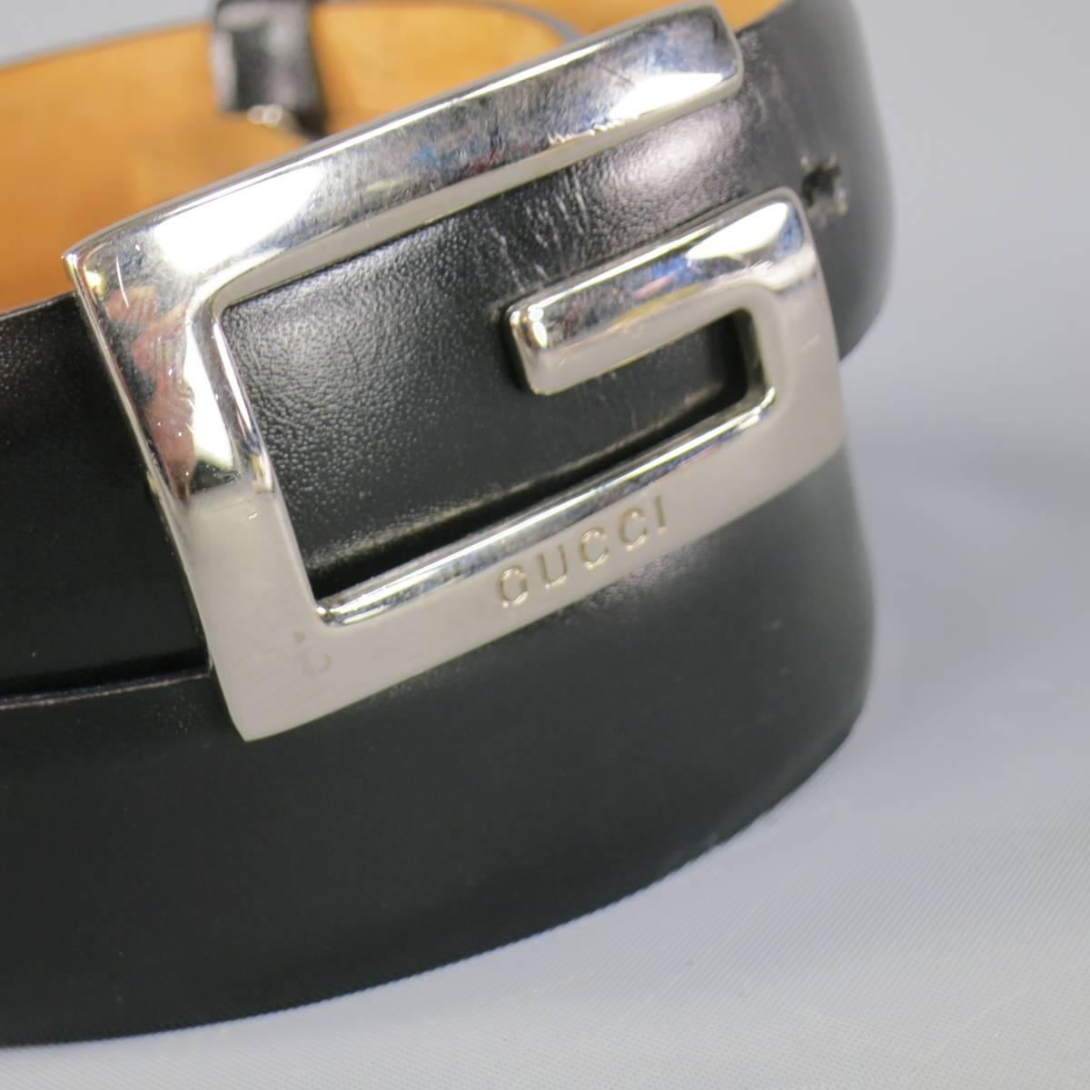 Classic GUCCI skinny belt with a smooth black leather strap and silver tone metal engraved G buckle. Minor wear. Made in Italy.
 
Good Pre-Owned Condition.
Marked: 70.28 036.1046.1004
 
Length: 34 in.
Width: 1 in.
Fits: 26.5-28.5 in.