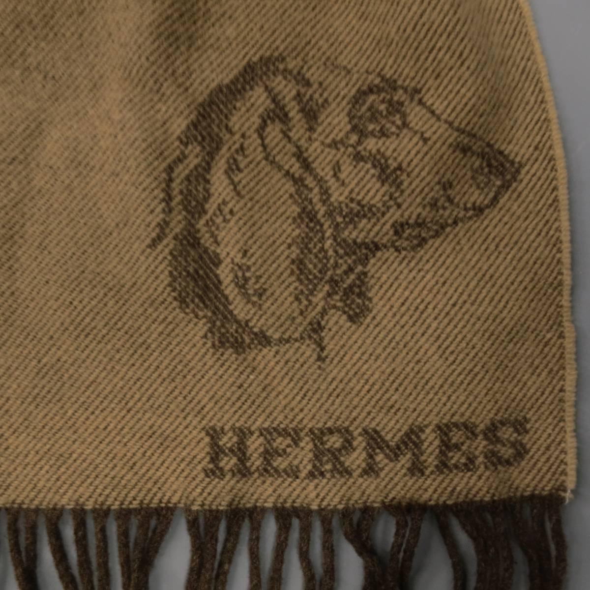 Vintage HERMES scarf in a beige cashmere wool blend knit with brown diagonal stripes, fringe hem, and Dachshund wiener dog head graphic. Made in Scotland.
 
Excellent Pre-Owned Condition.
 
Length: 68 in.
Width: 15 in.