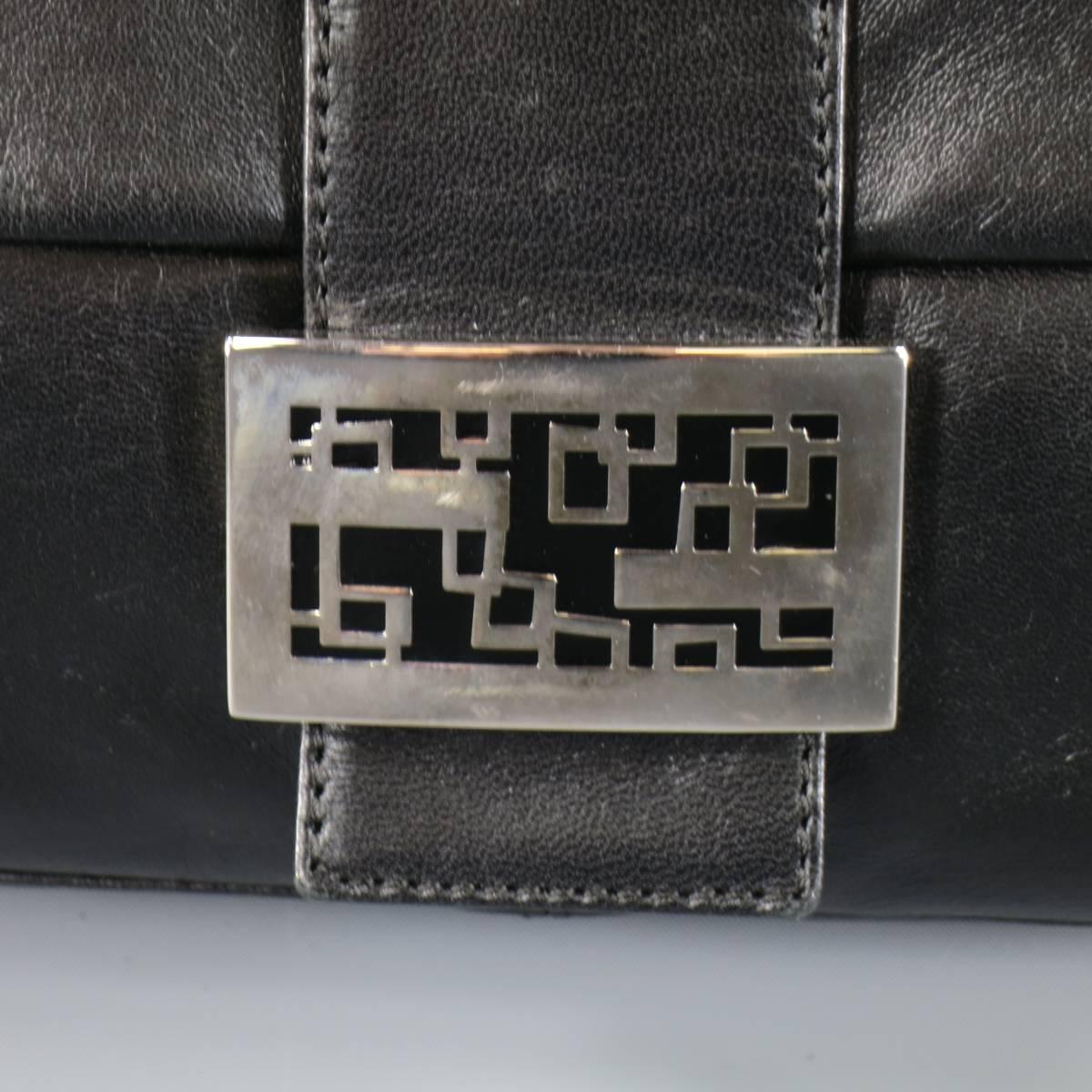 Classic FENDI rectangular handbag comes in a soft, smooth leather and features a fold over snap closure with geometric silver metal and black enamel buckle detail. Made in Italy.
 
Good Pre-Owned Condition.
 
Measurements:
 
Length: 10.5 in.
Width: