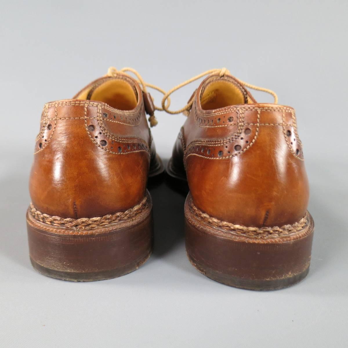 STEFANOBI Lace Up Shoe consists of leather material in a tan color tone. Designed in a square toe front, perforated wing-tip front with cap-toe detailing. Contrast stitching throughout body and brown leather sole. Made in Italy.
 
Good Pre-Owned