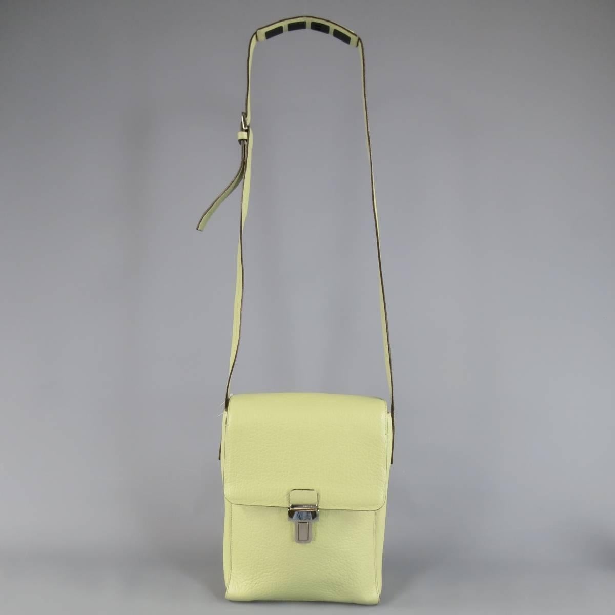 Vintage BALLY bag in a unique mint greenish tone beige textured leather featuring a flap with silver tone buckle, double storage compartments, and shoulder strap with rubber grip panel. In excellent condition with exception of the buckle being