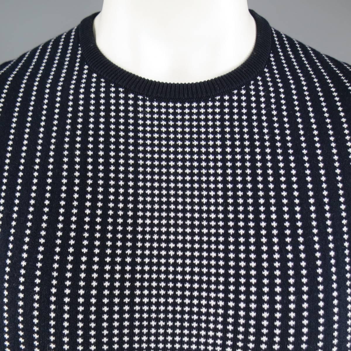 Chic JIL SANDER pullover sweater in a deep navy blue stretch cotton knit featuring a ribbed crew neck, short sleeves, and all over white spotted gradient pattern. Made in Italy.
Retails at $530.00.

New with Tags.
Marked: IT 50
 
Measurements:
