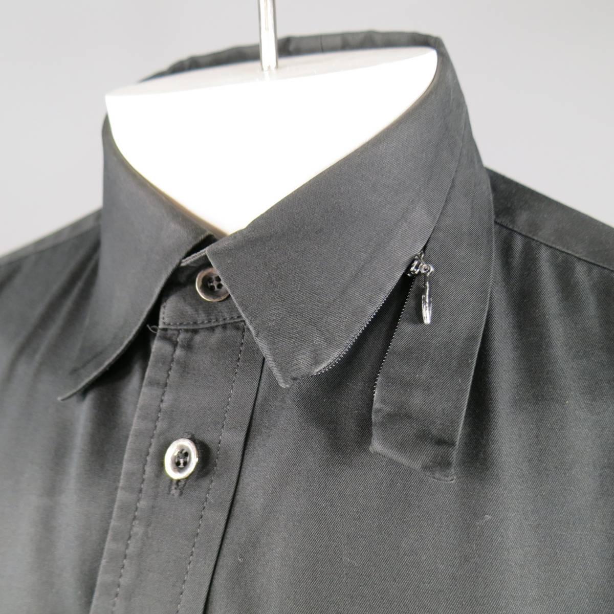 Vintage YOHJI YAMAMOTO shirt in a black cotton twill featuring a patch breast pocket, zip and button cuffs, and unique half zip collar. Fading throughout. As-Is. Made in Japan.
 
Fair Pre-Owned Condition.
Marked: JP 3
 
Measurements:
 
Shoulder: 18