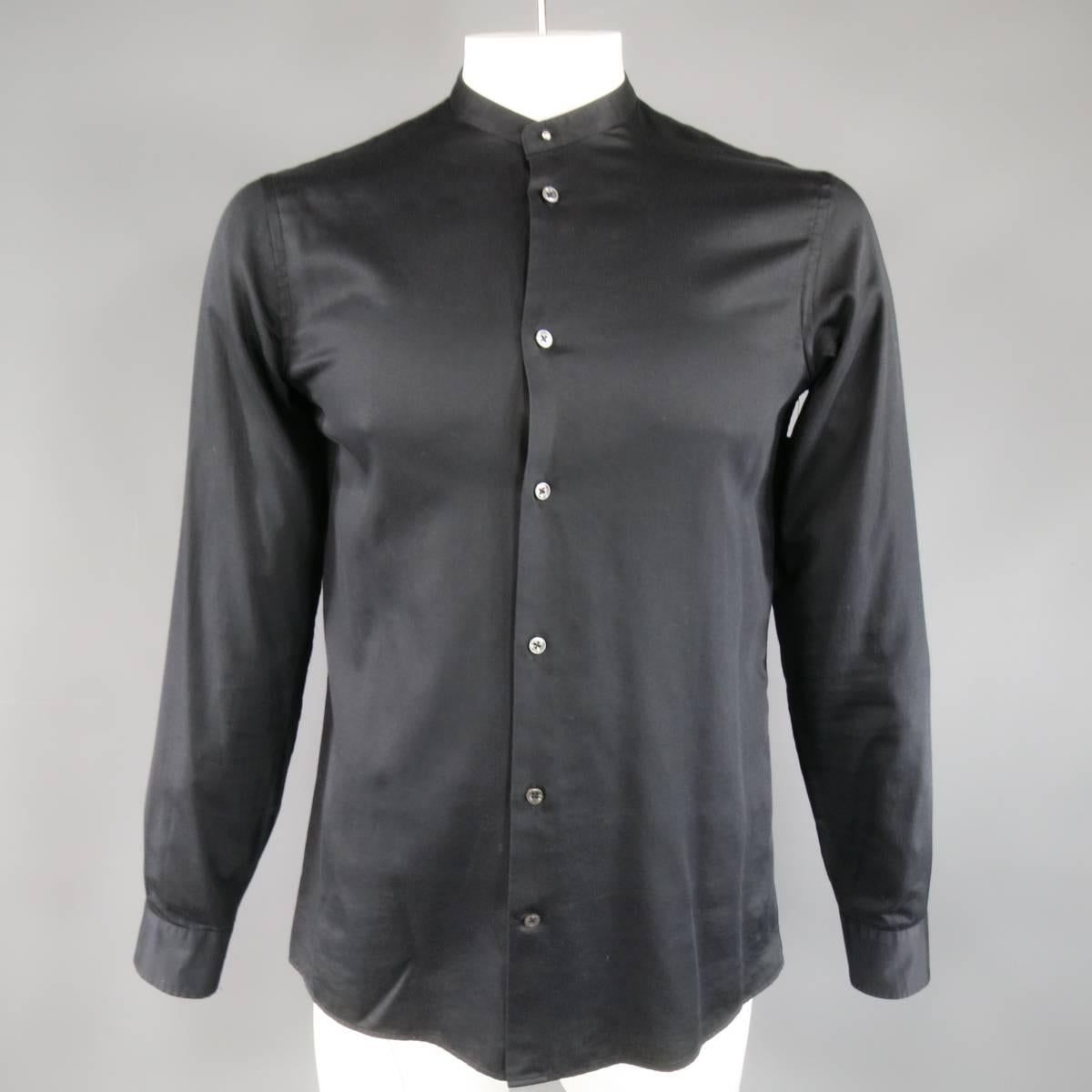 This classic MAISON MARTIN MARGIELA shirt comes in a light weight black cotton and features a detachable pointed collar with button stud, and signature white stitches at back. Made in Italy.
 
Excellent Pre-Owned Condition.
Marked: IT 50
