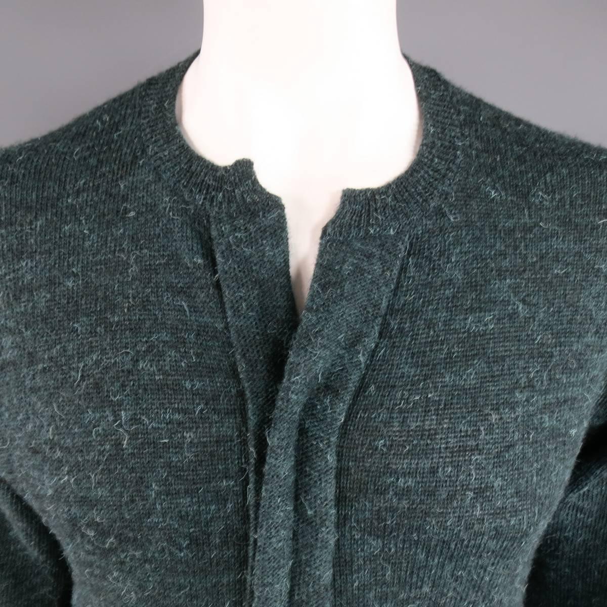 Vintage COMME des GARCONS HOMME pullover sweater in a forest green Heather textured fuzzy wool knit featuring a slit ribbed crewneck with frontal seam. Made in Japan.
 
Excellent Pre-Owned Condition.
Marked: JP 3 (AD 1997)
 
Measurements:
