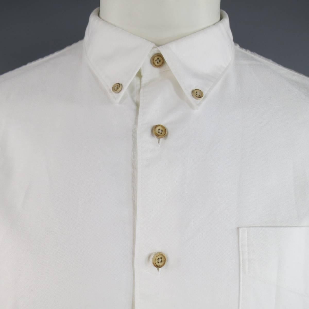 VISVIM Long Sleeve Shirt consists of 100% cotton material in a white color tone. Designed in a button-down front, single patch pocket with double button cuffs. Detailed with wooden buttons, elbow patches and "I.C.T" red stitching on right