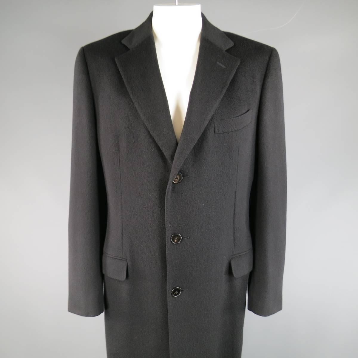 Classic overcoat by ERMENEGILDO ZEGNA in a soft, textured pure cashmere fabric featuring a notch lapel, three button closure, flap pockets, functional button cuffs, and full length hem. Made in Italy.
 
Excellent Pre-Owned Condition.
Marked: IT 54