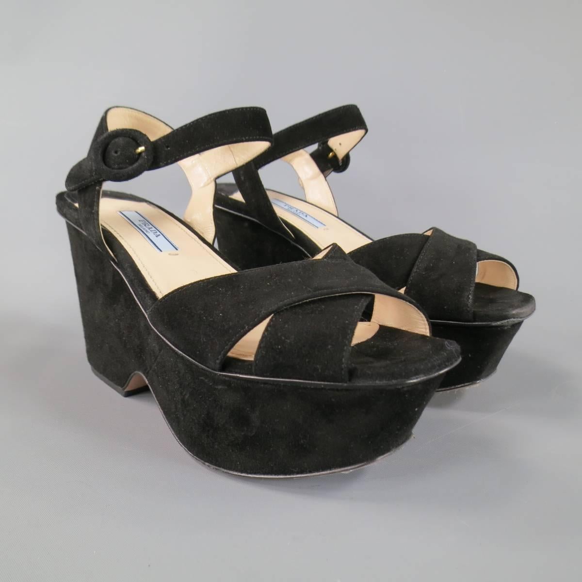 Retro inspired PRADA sandals in a plush black suede featuring a crossed peep toe strap, ankle harness, and chunky platform. Made in Italy.
 
Excellent Pre-Owned Condition.
Marked: IT 36.5
 
Heel: 4 in.
Platform: 2 in.