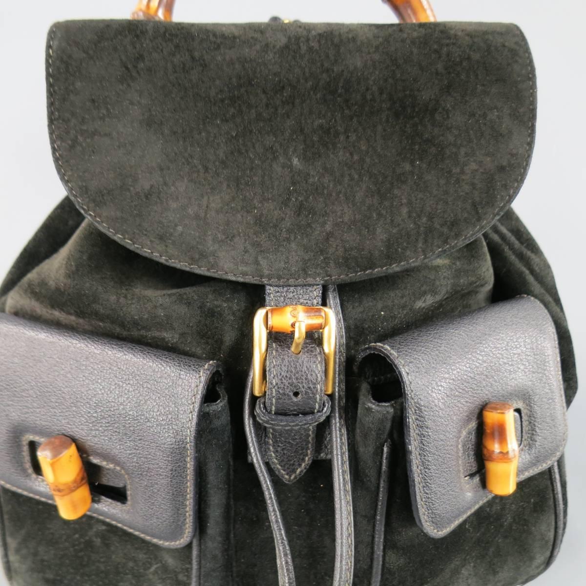 Vintage GUCCI backpack in black suede featuring double patch pockets with leather flap and bamboo closure, drawstring top, flap with buckle closure, and bamboo handle. Minor aging throughout suede. Made in Italy.
Retails at $2500.00.

Good Pre-Owned