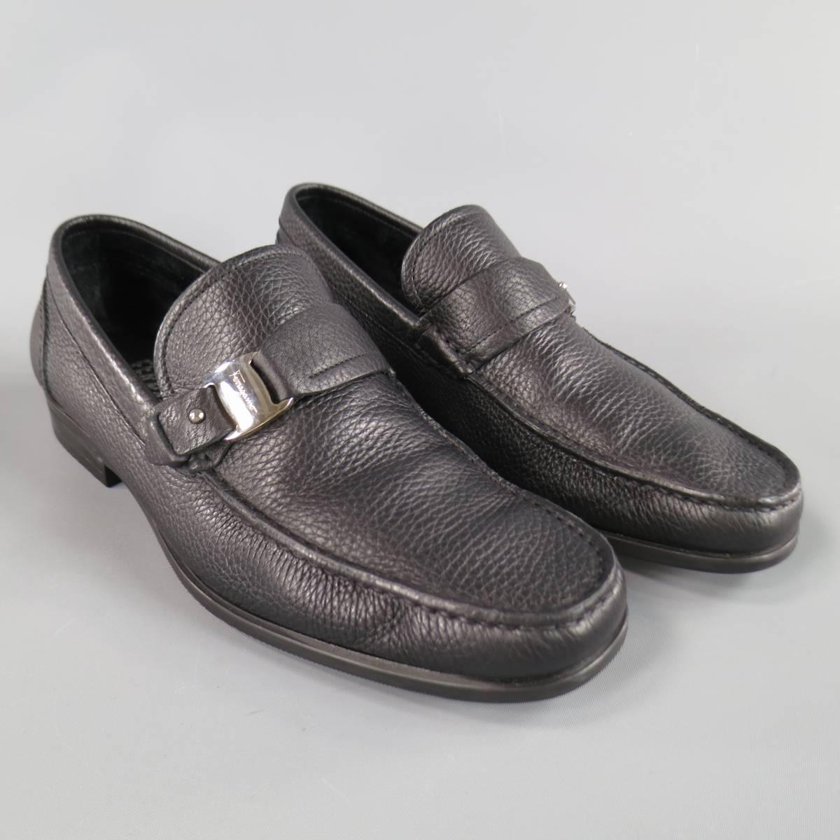 SALVATORE FERRAGAMO Loafer consists of leather material in a black color tone. Designed in a round toe front, moc.toe with silver tone buckle strap. Detailed in a pebbled texture and rubber sole. Made in Italy.
Retails at $495.00.

Excellent