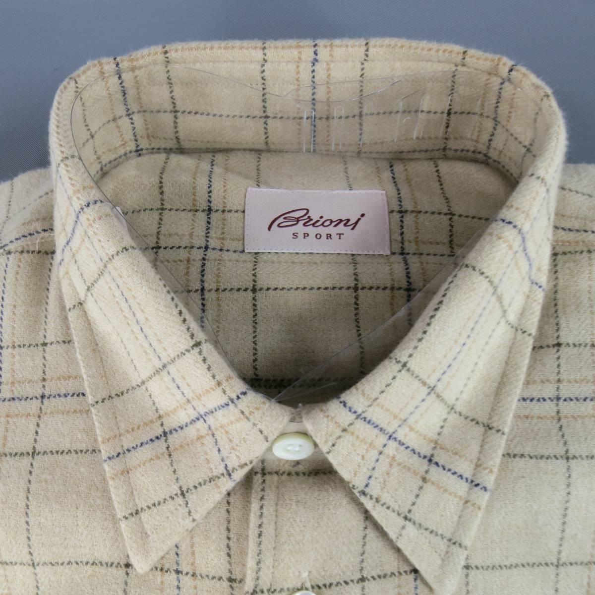 BRIONI Long Sleeve Shirt consists of cotton material in a khaki color tone. Designed in a button-up style, double button cuff with window pane pattern. Detailed with navy, tan and green stripes. New with tags. Made in Italy.
 
New Pre-Owned