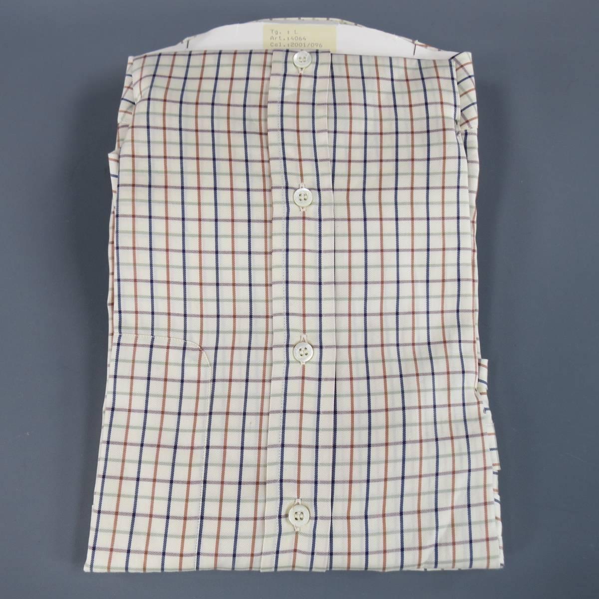 BRIONI Long Sleeve Shirt consists of cotton material in a beige color tone. Designed in a button-down front, patch pocket with double button cuffs. Detailed with a checkered pattern in blue, tan and green. New with tags. Made in Italy.
 
New