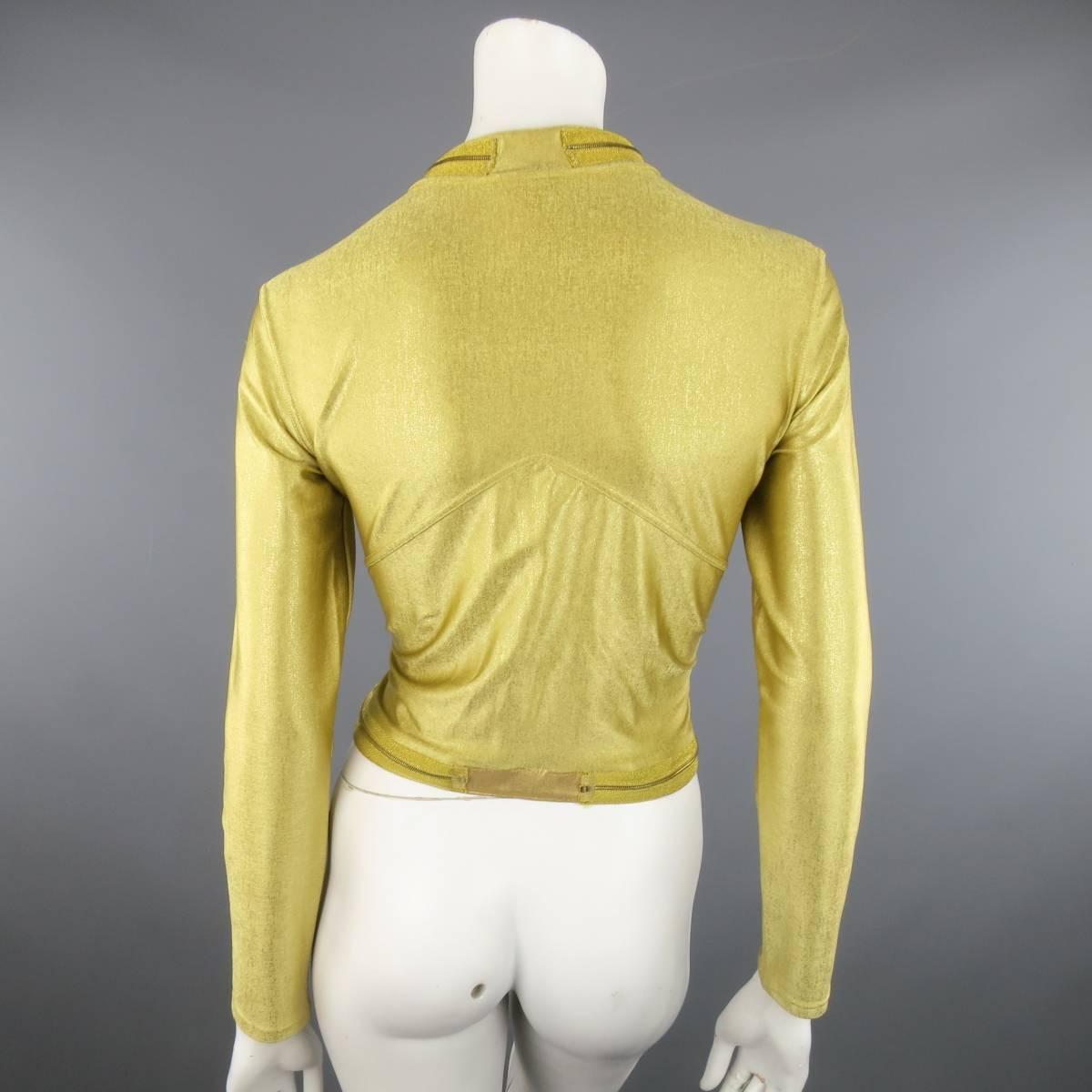 Vintage CHANEL cropped moto style jacket in light weight, stretchy metallic gold lame' featuring a stand up zip collar and waistband. Made in France.
 
Excellent Pre-Owned Condition.
Marked: FR 42 01C
 
Measurements:
 
Shoulder: 16.5 in.
Bust: 38