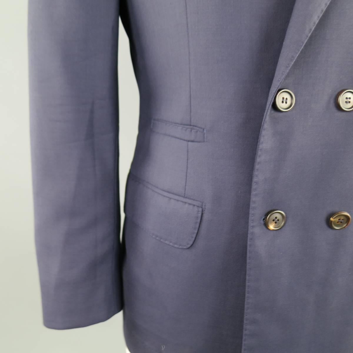 BRUNELLO CUCINELLI Sport Coat consists of wool material in navy color tone. Designed in a double-breast front, peak lapel collar and 4 button sleeve cuffs. Detailed  with a top pocket square and bottom flap pockets. Double back vent with half