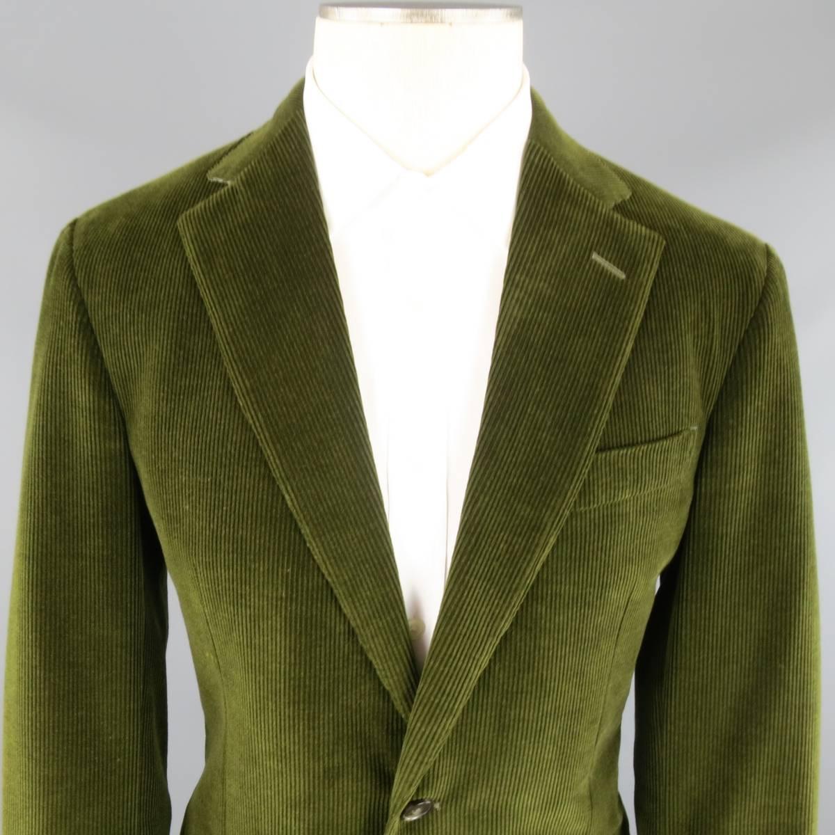 ERMENEGILDO ZEGNA Sport Coat consists of corduroy material in a olive color tone. Designed in a 2 button front, notch lapel collar and 4 button cuff sleeves. Detailed with a top pocket square and bottom flap pockets. Double back vent and full lining