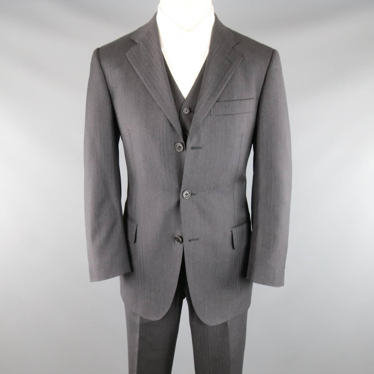 This SALVATORE FERRAGAMO three piece suit comes in a charcoal gray herringbone wool fabric and includes a three button, notch lapel sport coat, V neck vest, and cuffed hem trousers. Made in Italy.
Retails at $2650.00.
 
Excellent Pre-Owned