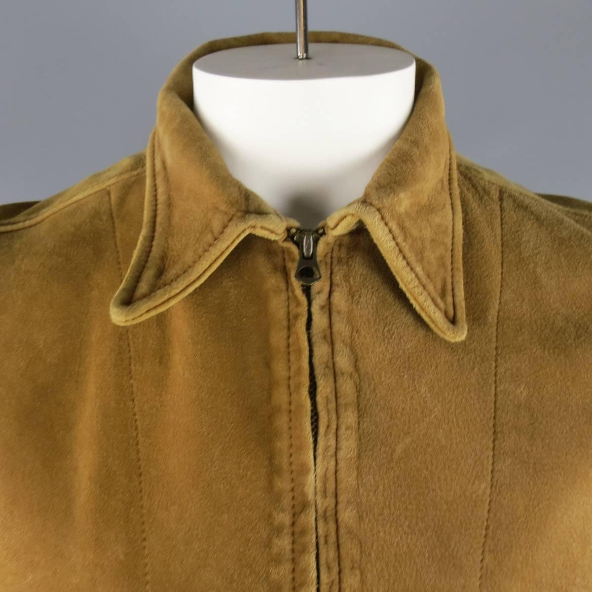 LEVI'S VINTAGE Jacket consists of sheep skin material in a tan color tone. Designed with a brass zip-up front, pointed collar and bottom inseam pockets. Detailed in a distressed overall look, adjustable double-button cuffs and waist band. Made in