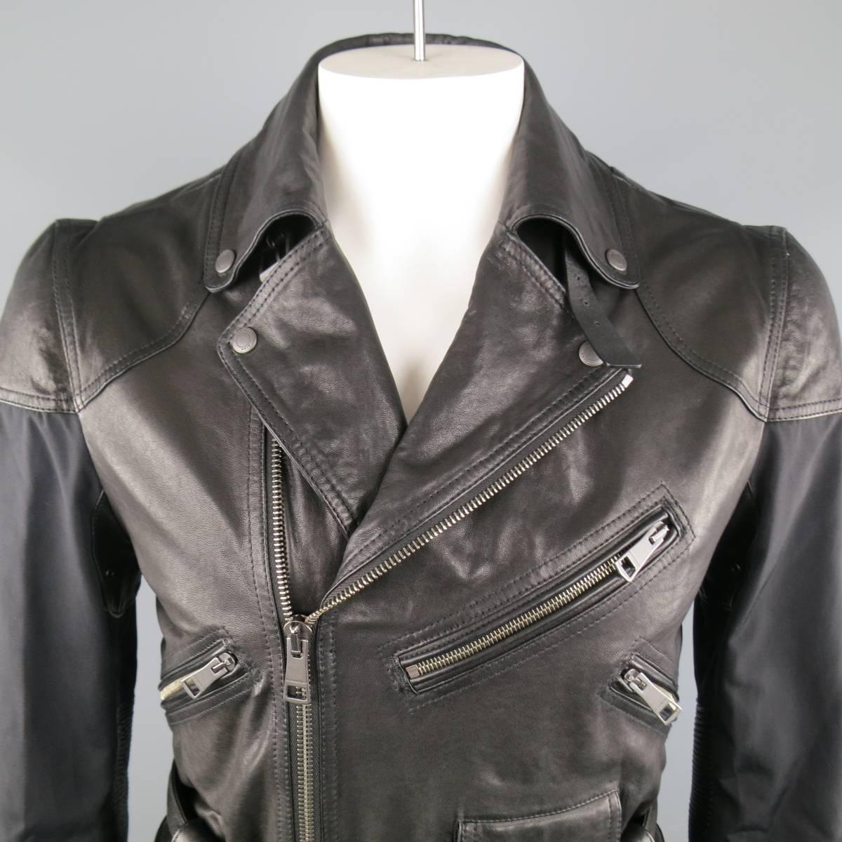 BURBERRY BRIT Jacket consists of nylon and leather material in a black color tone. Designed in a moto/field style jacket, asymmetrical zip-up front, notch collar with buckle closure underneath. Detailed with multi-zipper front, waist belt, bottom