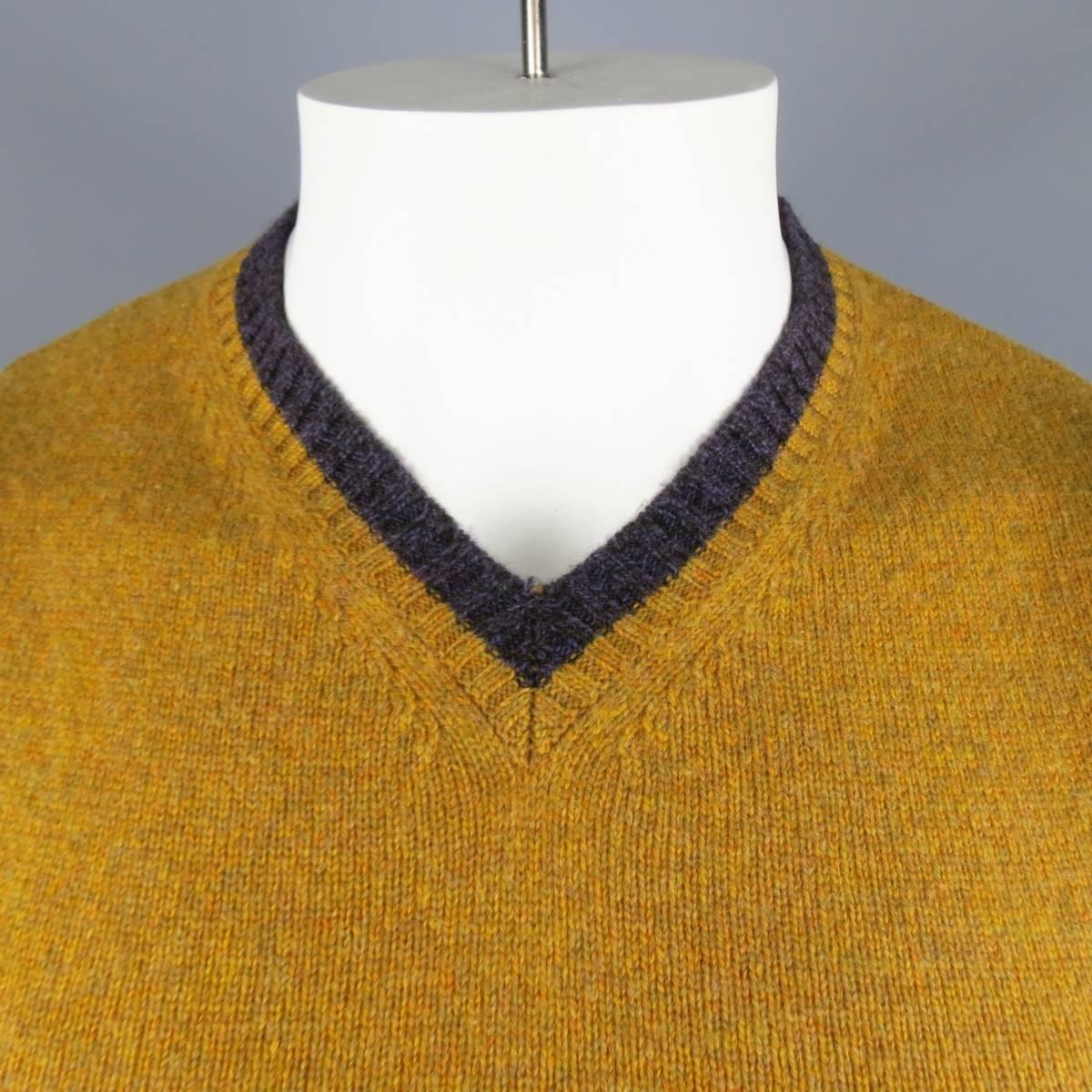 ETRO Vest consists of merino wool material in a mustard (gold) color tone. Designed in a v-neck collar, color blocked with purple accents. Detailed in a heather pattern. Made in Italy.
 
Excellent Pre-Owned Condition
Marked Size: M
 
Measurements
