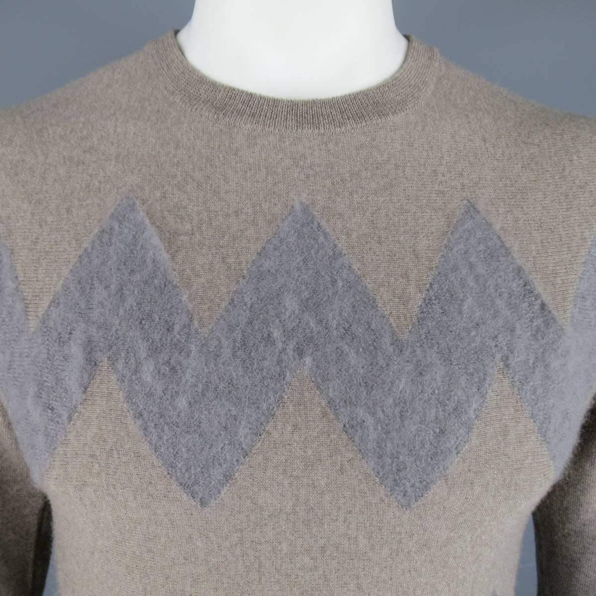 VIKTOR & ROLF Sweater consists of wool/mohair material in a taupe color tone. Designed in a crew-neck collar, zig-zag front pattern with mohair detail in grey and brown. Made in Italy.
 
Excellent Pre-Owned Condition
Marked Size: M
 
Measurements
