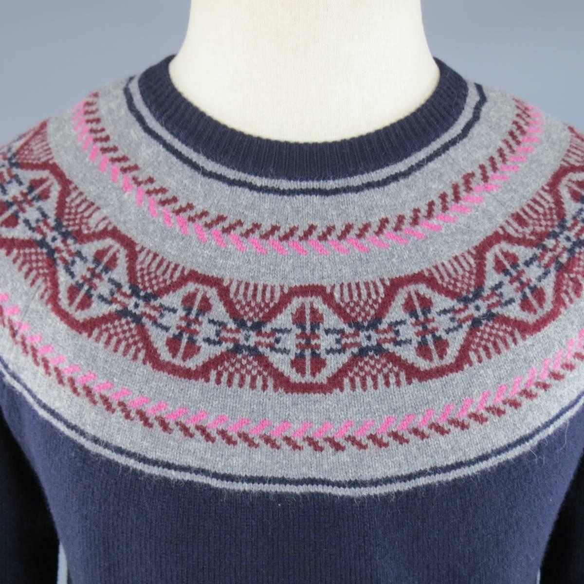 MICHAEL BASTIAN Sweater consists of wool blend material in a navy color tone. Designed in a crew-neck collar with rib cuffs and hem. Detailed fairisle pattern around the collar with pink, burgundy and grey color tone. Made in Italy.
 
Excellent