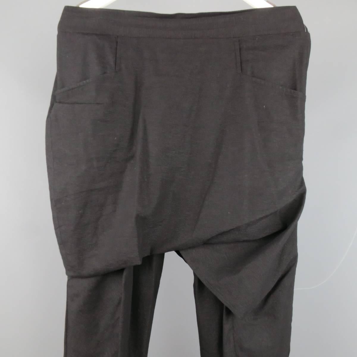 Edgy THAMANYAH drop crotch pants in a light weight stretch cotton material featuring a straight leg, back stretch waistband, and draped skirt overlay with pockets. Made in Italy.
 
Excellent Pre-Owned Condition.
Marked: IT 46
 
Measurements:
