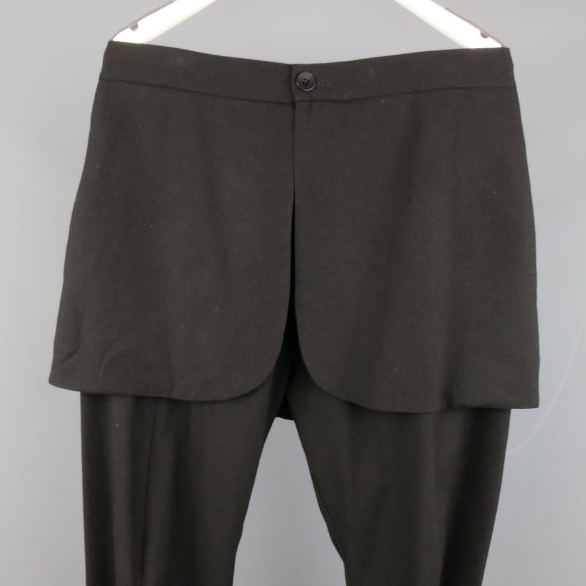 Edgy THAMAMYAH dress pants in a wool blend fabric featuring a tapered leg,  frontal seams, and slit skirt overlay. Made in Italy.
 
Excellent Pre-Owned Condition.
Marked: IT 46
 
Measurements:
 
Waist: 35 in.
Rise: 14.5 in.
Inseam: 24 in.
